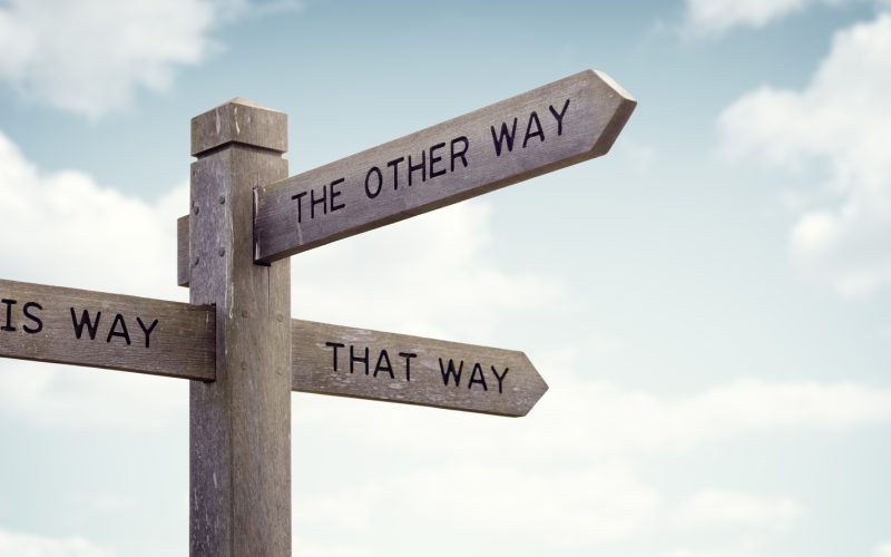 Crossroad signpost saying this way, that way, the other way concept for lost, confusion or decisions